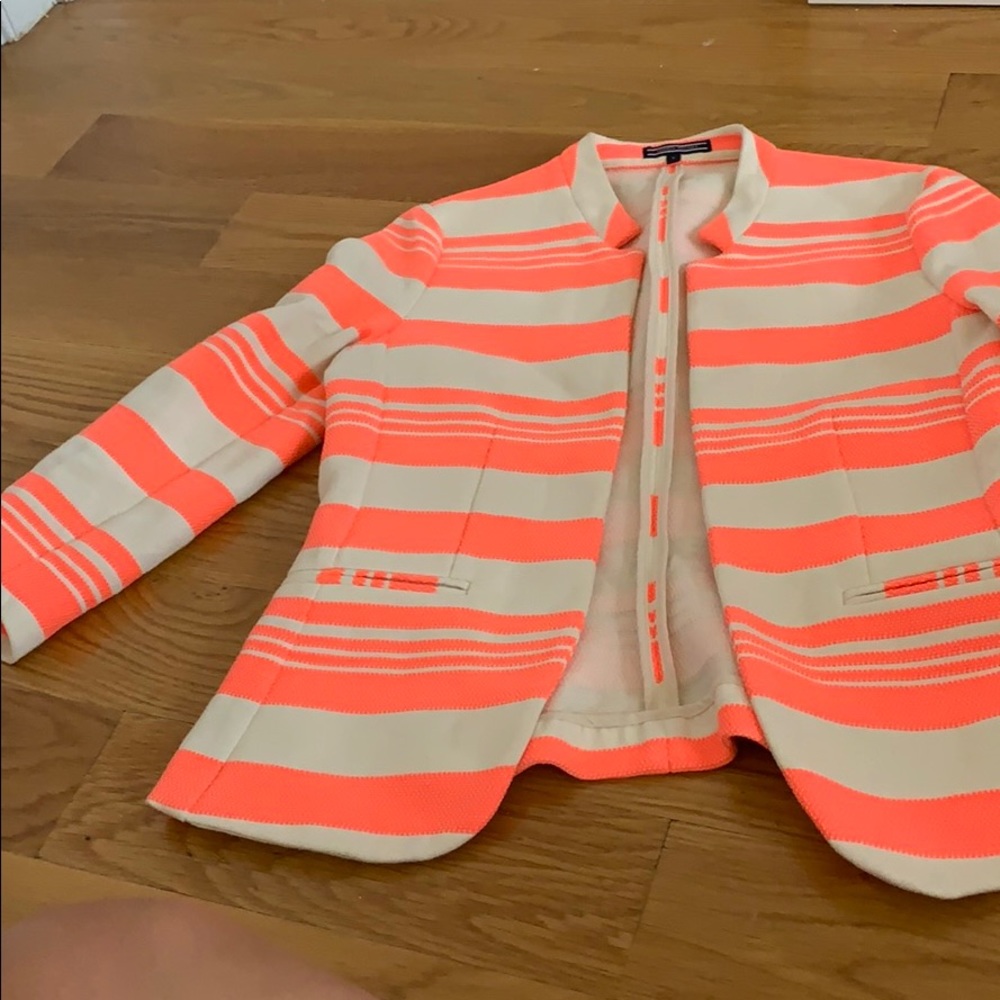 A neon pink and white blazer